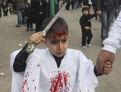 A Shi'ite Muslim boy taps his head with a blade to draw blood during a ceremony marking Ashura in Nabatieh, south Lebanon, December 27, 2009