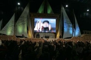 Lebanon's Hezbollah leader Sayyed Hassan Nasrallah addresses supporters via a screen during a religious ceremony in the suburbs of Beirut December 17, 2009.