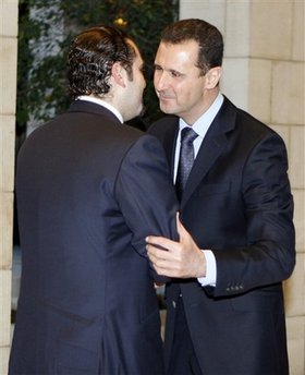 Syria's President Bashar al-Assad (R) welcomes Lebanese Prime Minister Saad al-Hariri at the Tshreen presidential palace in Damascus December 19, 2009.