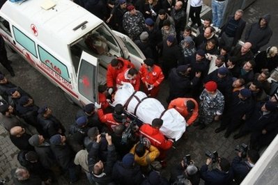 Red Cross paramedics carry to the body of one of the victims of the Ethiopian Boeing 737 crash into the mortuary of a government hospital in Beirut