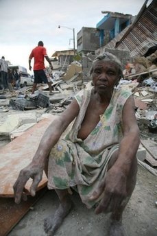 A woman sits amid the rubble in Port-au-Prince after a huge earthquake rocked the impoverished Caribbean nation of Haiti.