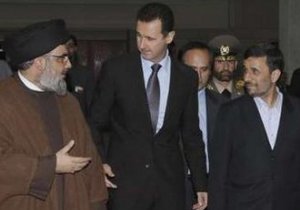 Lebanon's Hezbollah leader Sayyed Hassan Nasrallah (L) chats with Syria's President Bashar al-Assad (C) and Iran's President Mahmoud Ahmadinejad (R) while on their way to an official dinner in Damascus February 25, 2010.