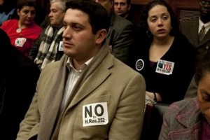 People wear signs in support and opposition at a House Foreign Affairs Committee hearing on Capitol Hill in Washington, Thursday, March 4, 2010,