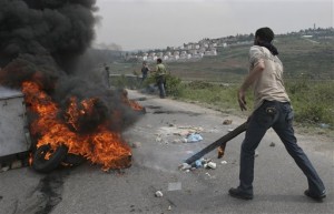 Palestinians burn tires during a demonstration against the expansion of the Jewish settlement of Halamish, in the West Bank village of Nabi Saleh near Ramallah, Friday, April 16, 2010. AP 