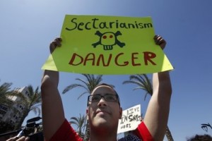 Lebanese secular activist, holds up a banner during a march calling for secularism and the abolishment of sectarianism, in Beirut, Lebanon, Sunday April 25, 2010.