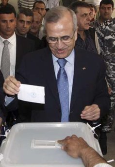 Lebanon's President Michel Suleiman casts his vote during the country's municipal elections at a polling station in his hometown of Amchit 