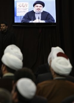 Hezbollah leader Hassan Nasrallah speaks via a video link during a rally commemorating the death of thee Hezbollah leaders