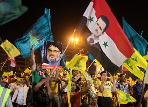 hezbollah supporters of assad wave flags