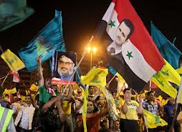 hezbollah supporters wave syrian flags