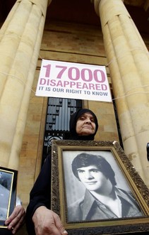 A Lebanese woman holds the image of her missing son during rally outside the National Museum which stood along the demarcation line known as the "Green Line" marking the division between east and west Beirut on November 17, 2012. Participants marched along a route linking the Mathhaf area of Beirut, where a large number of disappearances took place, to three neighbourhoods where the state has recognised the presence of mass graves. AFP PHOTO/ANWAR AMRO