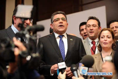 Ghassan Hitto (C) speaks to the press after being elected as the prime minister of the interim government of Syria's opposition, in Istanbul, Turkey, March 19, 2013. The Syrian opposition coalition elected Ghassan Hitto as the prime minister of its interim government early Tuesday morning as part of the efforts to establish a coherent and inclusive political body to administer the opposition-held areas in northern Syria. (Xinhua/Ma Yan)