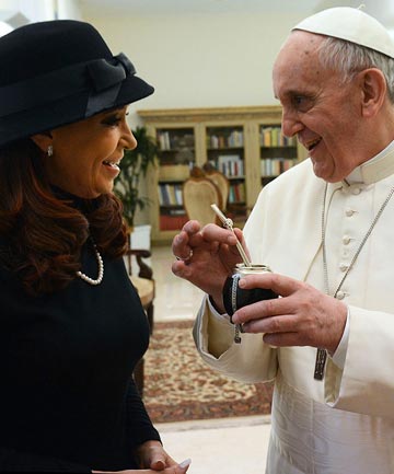 Newly elected Pope Francis, Cardinal Jorge Mario Bergoglio of Argentina, holds a mate given to him as a present from Argentine President Cristina Fernandez de Kirchner.