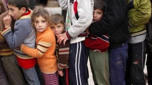 Syrian refugee children queue for aid