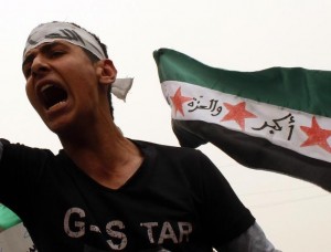 A demonstrator shouts a slogan during a protest held to mark two years since the start of the uprising in the country, in Raqqa province, eastern Syria March 15, 2013. REUTERS/Hamid Khatib