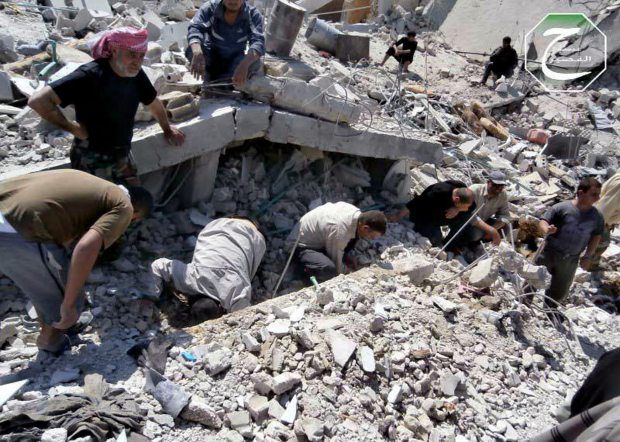 shows Syrian citizens inspecting the rubble of damaged buildings that were damaged from a Syrian forces air strike in the town of Qusair, near the Lebanon border, Homs province, Syria. Cut off for three weeks by a regime siege, doctors in the Syrian town of Qusair keep hundreds of wounded in storerooms and underground shop cellars, short on antibiotics and anesthesia, using un sterilized cloth for bandages and blowing air with pumps because there’s no oxygen canisters, amid relentless shelling and sniper fire. More than a dozen have died from untreated wounds and at least 300 others need immediate evacuation, one doctor says. (AP Photo/Qusair Lens, File)