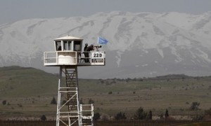 Soldiers of the U.N. Disengagement Observer Force (UNDOF), stand on an observation tower overlooking Syria and located on the Israeli side of the 1973 Golan Heights ceasefire line with Syria March 21, 2012. Blue-helmeted United Nations peacekeeping troops patrolling a slice of Syrian territory to maintain a ceasefire with Israel face new risks as violence between Syrian government loyalists and rebels gets closer. Picture taken March 21, 2012. REUTERS/Ronen Zvulun (POLITICS MILITARY CONFLICT)