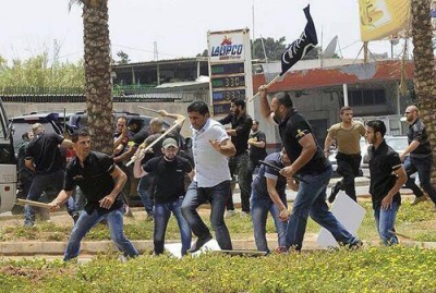 Hezbollah supporters attack  anti-Hezbollah protesters in front of the Iranian embassy in Beirut June 9, 2013. 