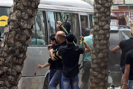 Hezbollah supporters attack a bus carrying anti-Hezbollah protesters in front of the Iranian embassy in Beirut June 9, 2013. REUTERS/ Stringer