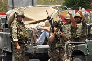 Lebanese army soldiers gesture as they capture a gunmen in Sidon, southern Lebanon