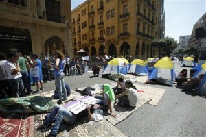 Protesters stage a sit-in demonstration against the postponement of June's parliamentary election until next year, near the parliament building in Beirut