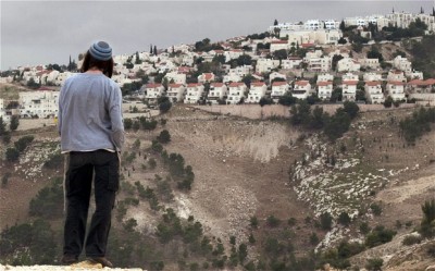 A Jewish settler looks at a West bank settlement on the outskirts of Jerusalem.  One perpetual sticking point between the Israelis and Palestinians is the fate of these settlements  