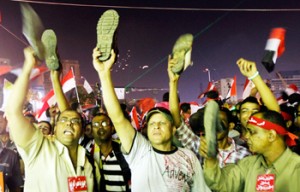 Anti-President Mohamed Morsi protesters hold up their shoes after a speech by Morsi, at Tahrir Square in Cairo on July 3, 2013. Mohamed Abd El Ghany/Reuters Read more at: http://indiatoday.intoday.in/story/egypt-president-morsi-egypt-army-facebook-the-final-hours-morsi-ultimatum/1/286576.html