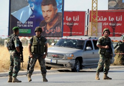 Lebanese soldiers stand guard at the scene of a car bomb attack that targeted a Hezbollah convoy travelling towards the Lebanese border crossing with Syria, on the Majdal Anjar-Masnaa road on July 16, 2013. The bombing is the fourth time that a vehicle has been targeted by an explosive device in the Bekaa region, which is a stronghold of the Shiite Hezbollah movement. AFP PHOTO / STR