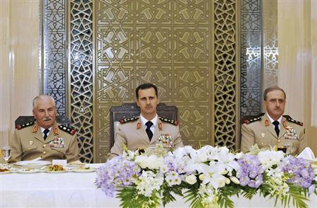 Syria's President Bashar al-Assad (C) attends a dinner in honor of the army officers on the 65th Army Foundation anniversary in Damascus August 1, 2010. On left is Syrian Defense Minister General Ali Habib and on right, Chief of Staff General Dawoud Rajha. REUTERS/Sana