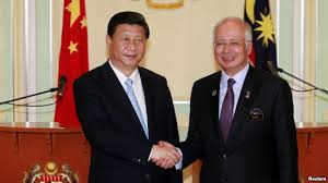 China's President Xi Jinping (L) and Malaysia's Prime Minister Najib Razak