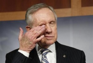 U.S. Senate Majority Leader Harry Reid (D-NV) rubs his eyes during a news conference after a bipartisan passage of a budget and debt legislation at the U.S. Capitol in Washington
