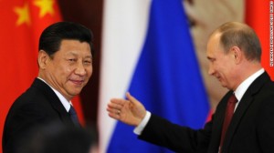 Russia's President Vladimir Putin greeting Chinese President Xi Jinping