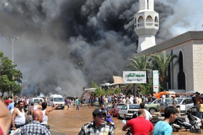 Smoke billows into the air after a bomb blast at a mosque in the northern Lebanese city of Tripoli in Aug  2013