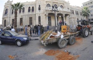 SANA handout shows people gathering around the scene of a bomb explosion in front of of al-Hijaz train station in Damascus