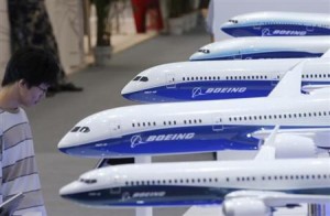 A visitor looks at a display of miniature Boeing passenger aircraft at Aviation Expo China 2013 in Beijing