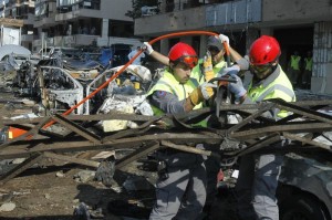 Hezbollah civil defense members work at the site of the two suicide bombings that occurred on Tuesday near Iran's embassy compound in Beirut