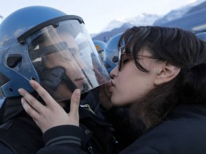 Italian protester kises police