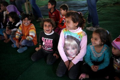  Syrian refugee girls laugh Sunday as they watch a show by Mabsutins, a comedian group from Europe, at Zaatari refugee camp near the Syrian border in Mafraq, Jordan.   AP