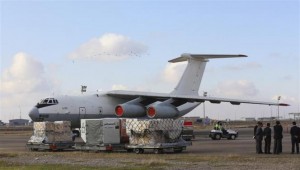 Workers load humanitarian aid from United Nations onto a plane for Syrian families, in Arbil airport