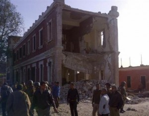 People and army personnel stand around a damaged bulding after an explosion in Egypt's Nile Delta town of Anshas, about 100 km (65 miles) northeast of Cairo