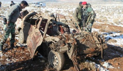 Members of the Lebanese army inspect the wreckage of the car .December 17, 2013. 