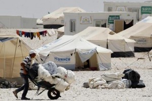 A newly arrived Syrian refugee receives aid and rations, at Al-Zaatri refugee camp in the Jordanian city of Mafraq