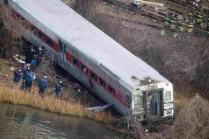 Emergency workers examine the site of a Metro-North train derailment in the Bronx borough of New York