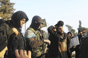 Fighters from the Islamic State in Iraq and the Levant (ISIL) try to calm civilians demonstrating against the rebel infighting in Aleppo