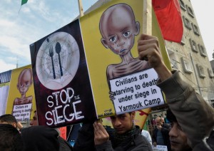 Palestinians take part in a solidarity with Palestinian children at Yarmouk refugee camp in Syria