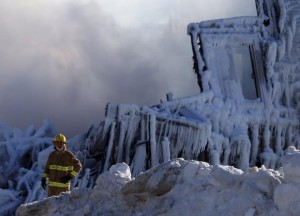 A firefighter looks on at the seniors residence Residence du Havre after a fire in L'Isle Verte