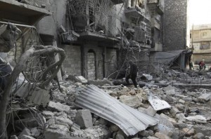 A man walks amid rubble of damaged buildings in the al-Myassar neighbourhood of Aleppo