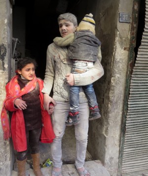 Children exit a building after what activists described as a wave of Syrian government airstrikes 