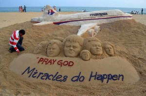 Indian artist Sudarshan Patnaik creates sand art sculpture for Malaysia Airlines Flight MH370 . Reuters