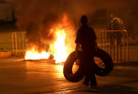 protester burns tires