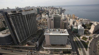 An aerial view shows the war-ravaged and deserted former Holiday Inn hotel (the tall building on the left), next to the Phoenicia hotel next in 2011.